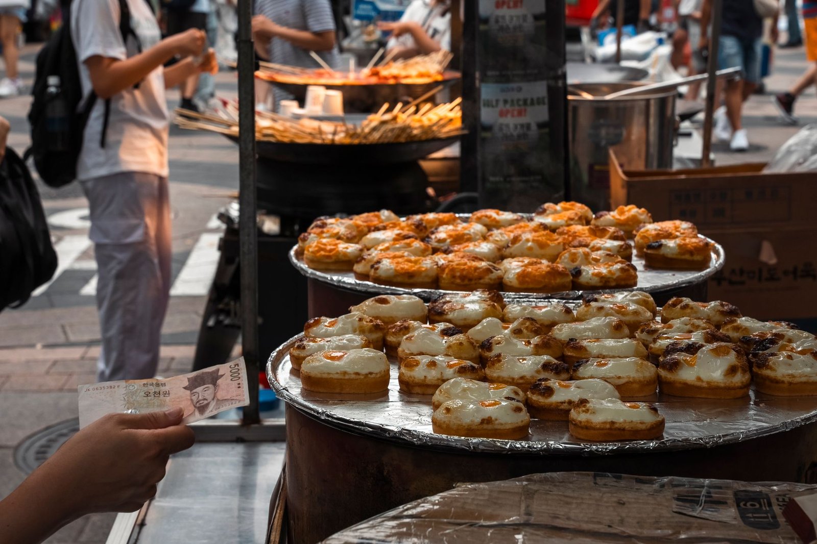 Explore the bustling street food scene in Seoul with delicious pastries on display