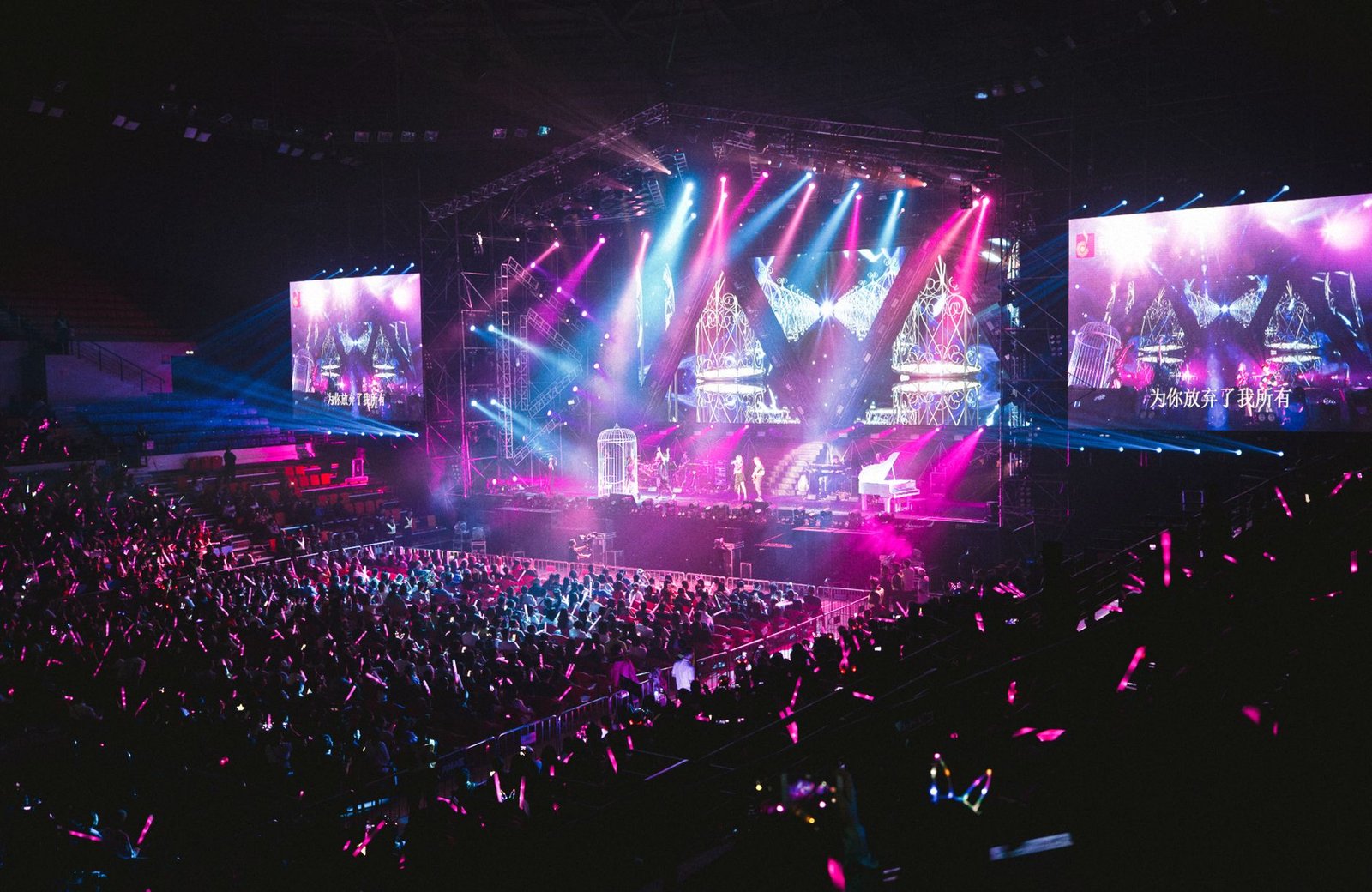 Colorful live concert with vibrant lighting, energetic crowd, and dynamic stage performance