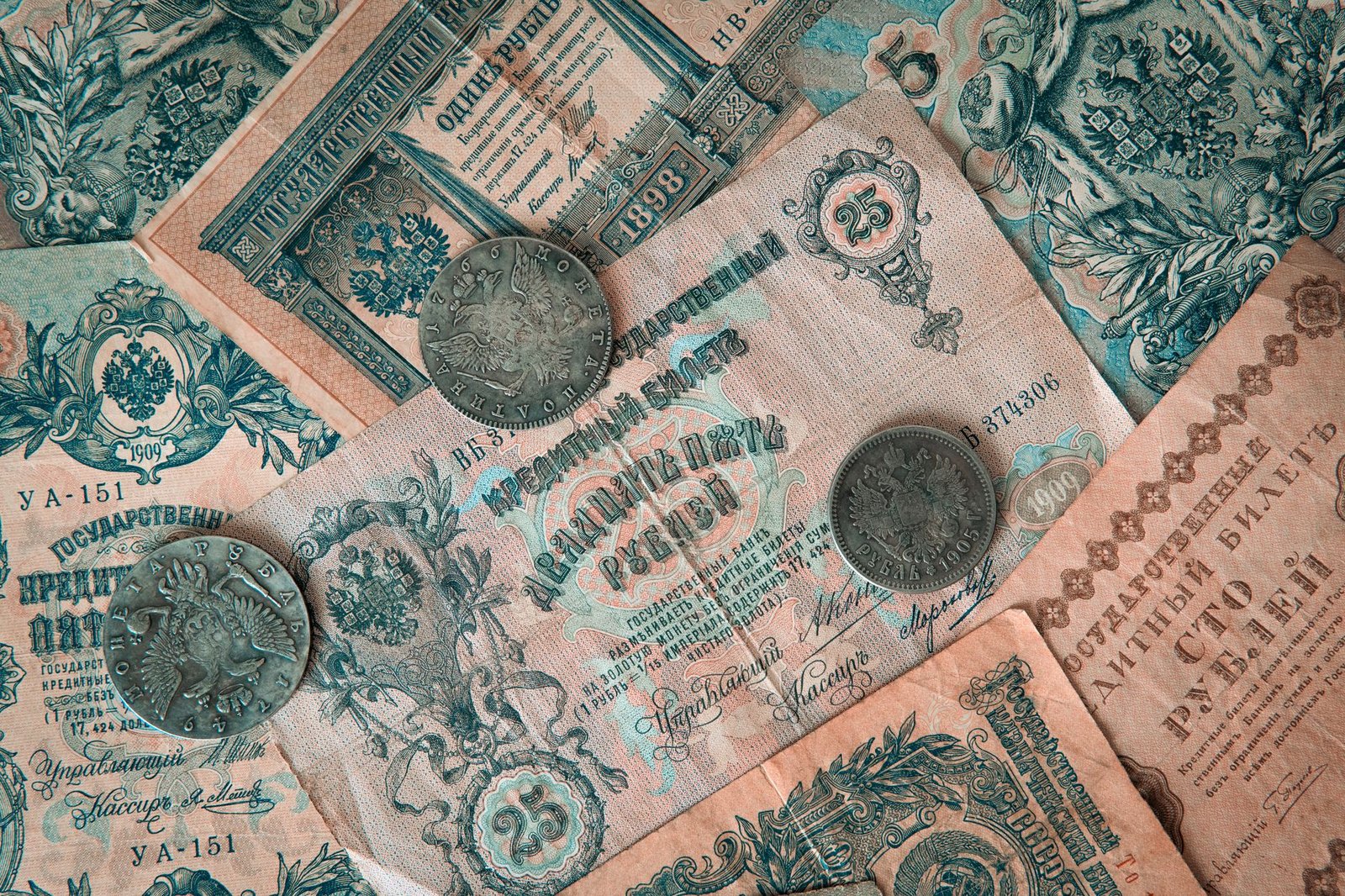 Collection of vintage Russian banknotes and coins featuring intricate designs