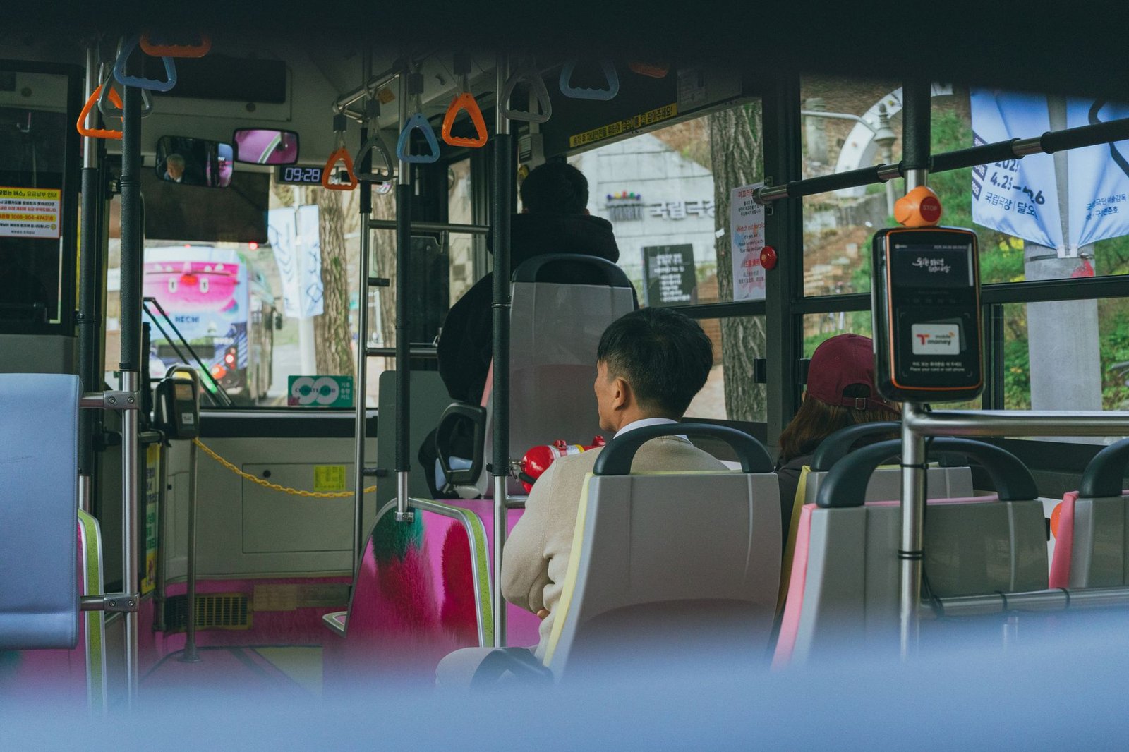 Passengers ride a bus in Seoul, showcasing everyday urban transportation in South Korea