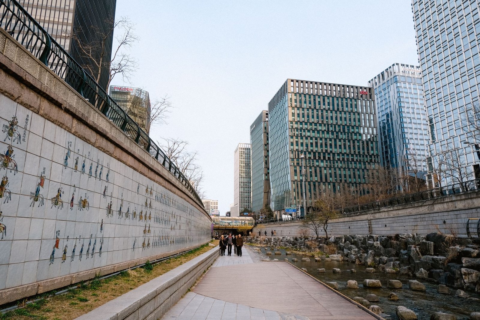 Riverwalk alongside modern Seoul skyscrapers, showcasing urban architecture and culture