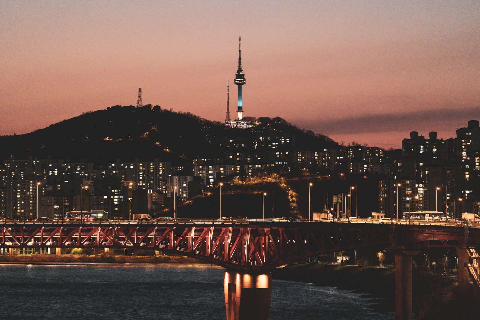 Stunning view of Seoul's skyline at twilight featuring Namsan Tower and illuminated bridge